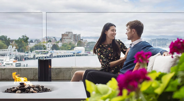 A couple sitting by a fire pit