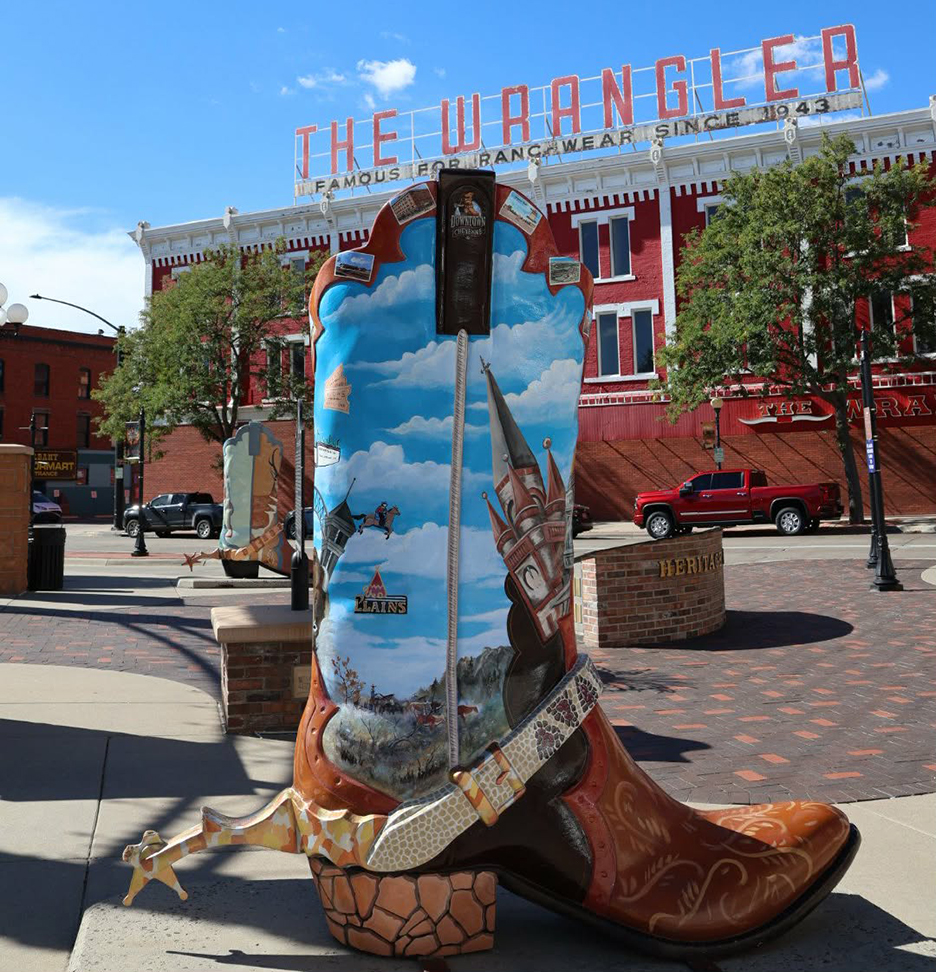 a western colored boot statue located in front of a wranler western store building