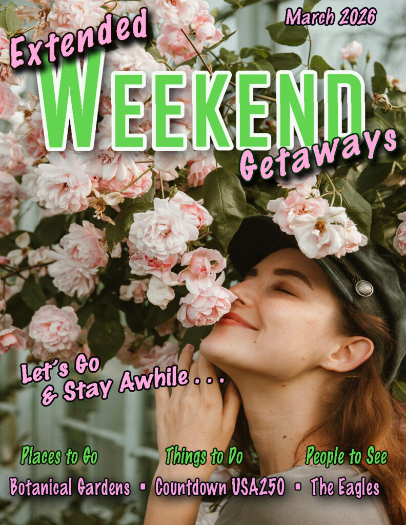 A headshot of a lady smelling pink roses and smiling