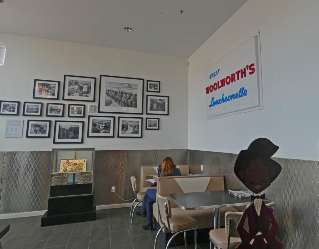 in a museum room with framed pictures on the wall