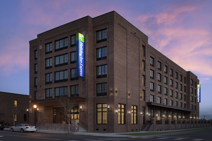 exterior shot of 5-floor brick square building viewable from the front corner of street