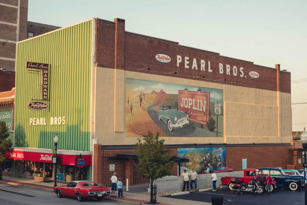 a downtown building with the side painted as a mural to promote Rte 66