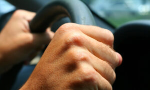 Hands gripping a steering wheel 