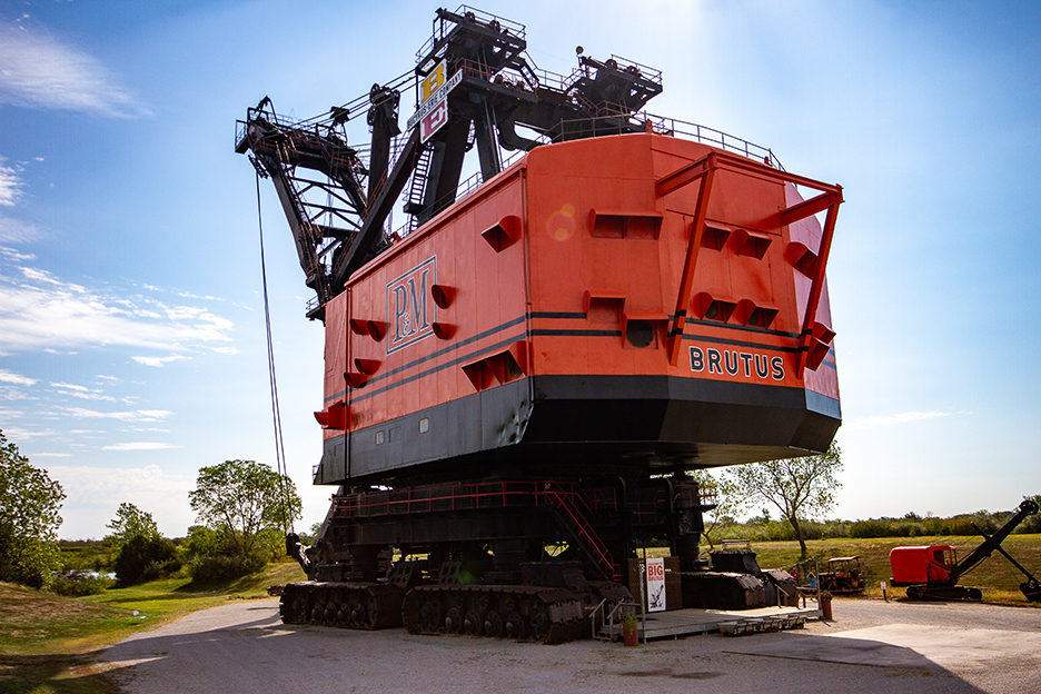 giant red bulldozer as larg as a factory building 
