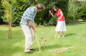 Family enjoying playing croquet together