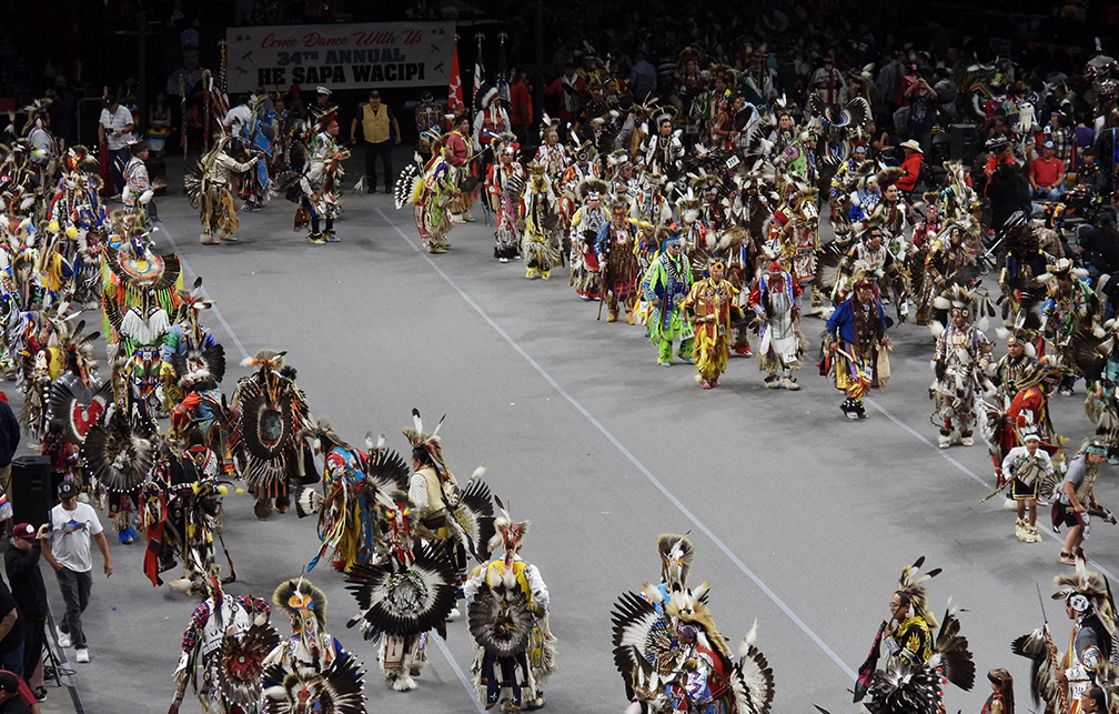 native indians in a group dancing their native steps
