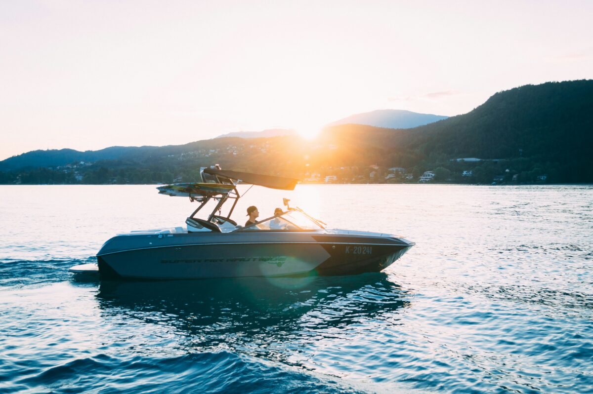 a boat on the waters of a lake with hills in background