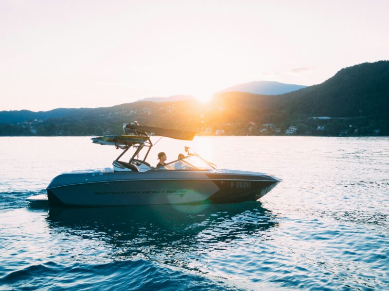a boat on the waters of a lake with hills in background