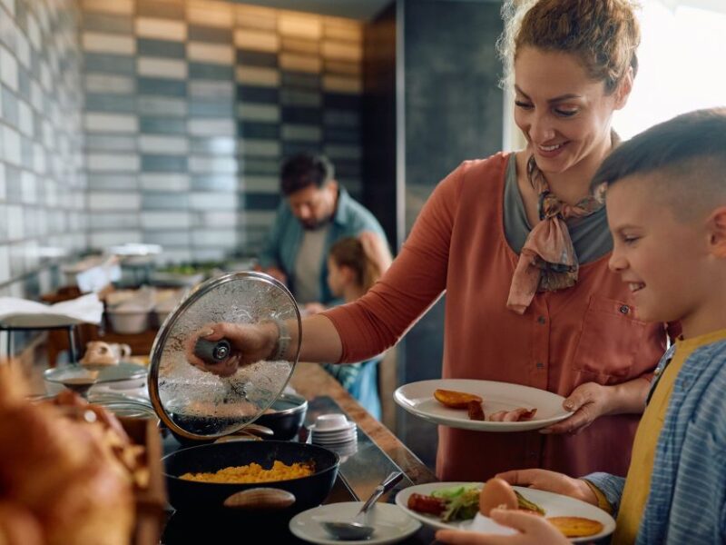 Family getting breakfast from hotel buffet