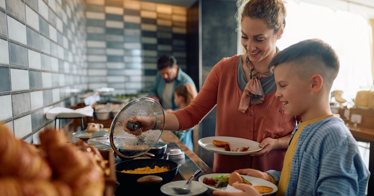 Family getting breakfast from hotel buffet