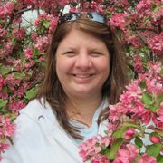 Headshot of girl surrounded by pink flowers