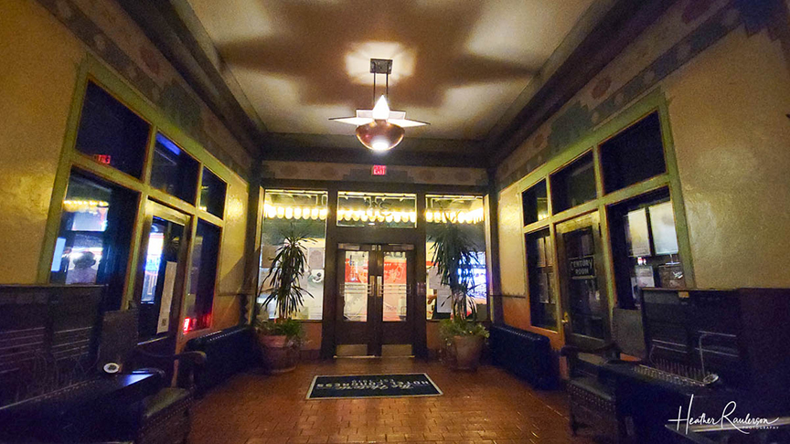 the inside of a hotel lobby shown with dark shadows