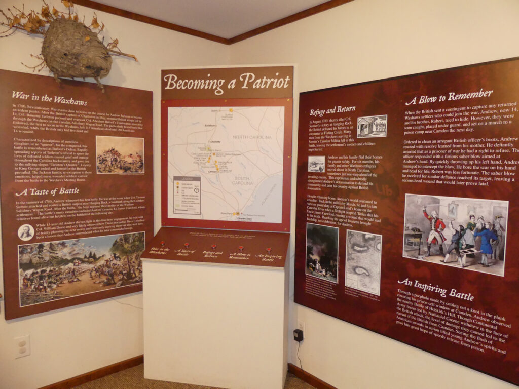 a corner wall in a museum with posters describing Andrew Jackson's connect in history