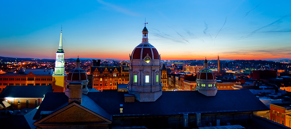 skyline of a city with a rounded dome top of building in center