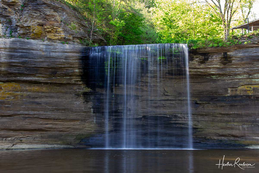 a waterfall over a cliff of rock