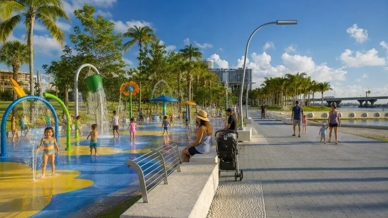a splashpad for kids along a city sidewalk