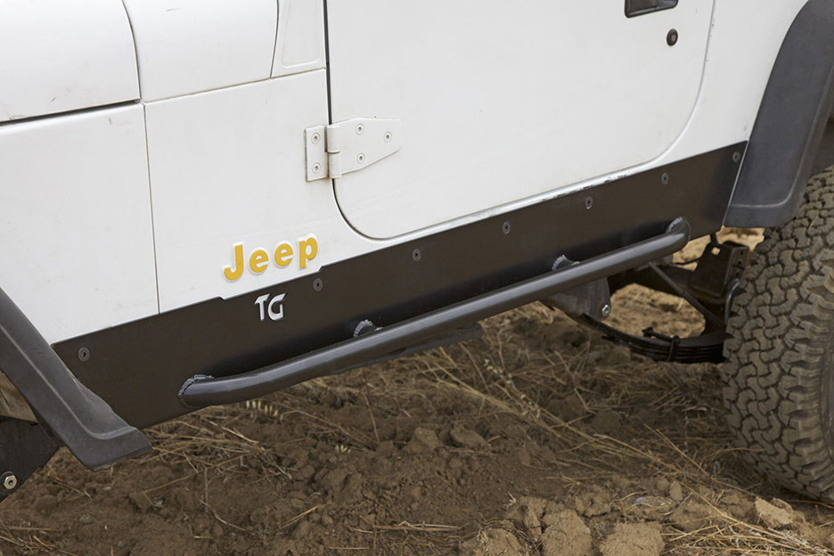 the side of a white jeep with installed rock slider