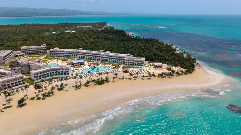 aireal view of a tropical island with beach and ocean at the right front corner of photo