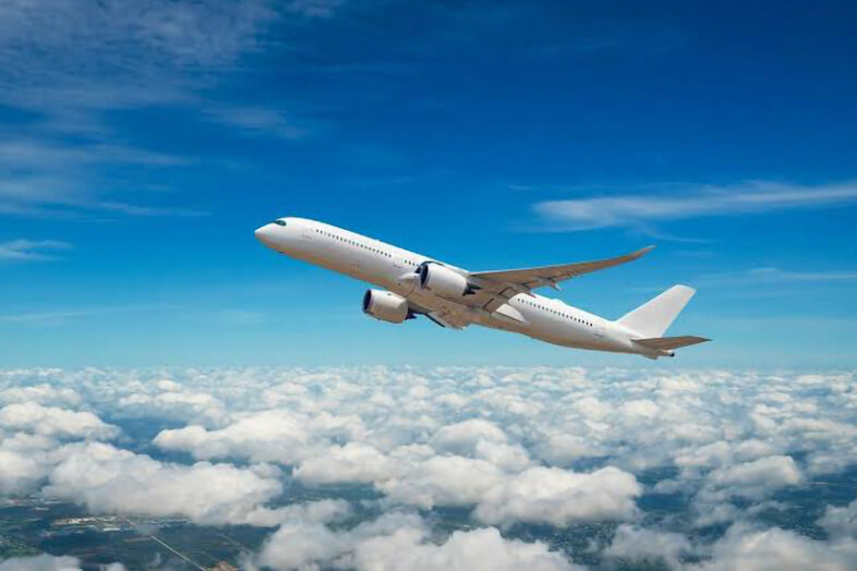 a single airplane flying in the sky