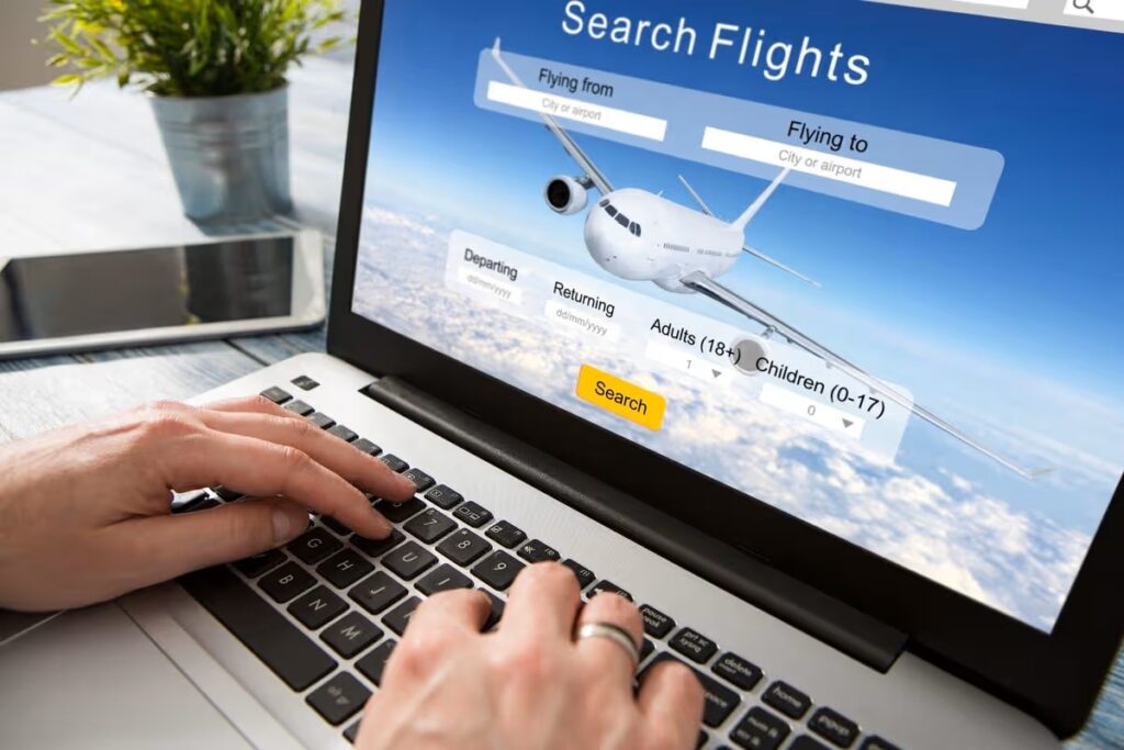 someone typing on a computer with the screen showing an airplane.
